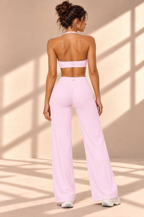 Back view of the Blush Eterno halter-style top and high-waisted pink wide-leg pants