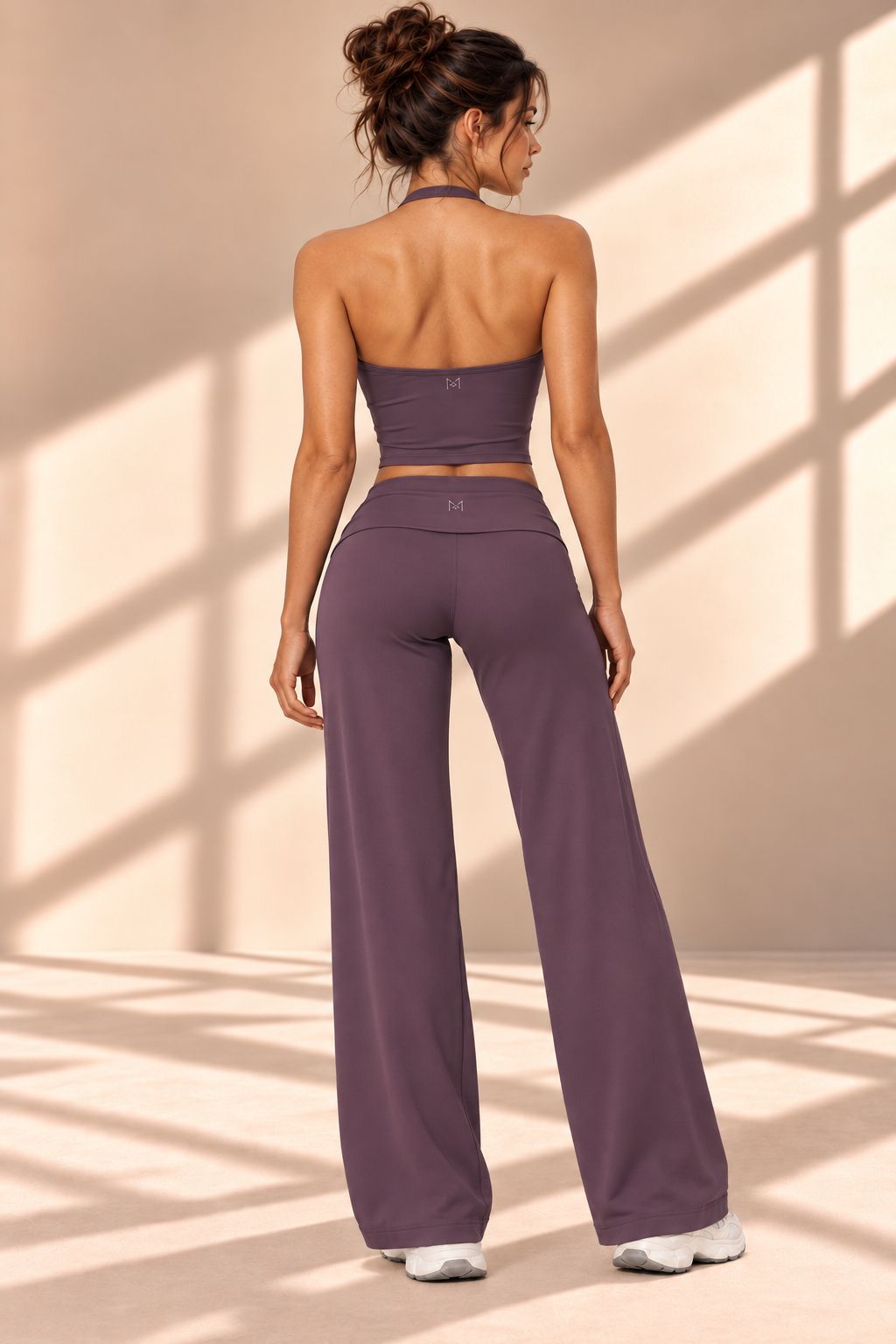 Back view of Mora Silvestre plum halter-style cropped top and high-waisted wide-leg pants