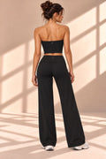 Front view of Ébano Lune black three-piece set with cropped top, jacket and wide-leg pants