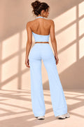Front view of Aire Celeste sky-blue three-piece set with jacket, cropped top and wide-leg pants