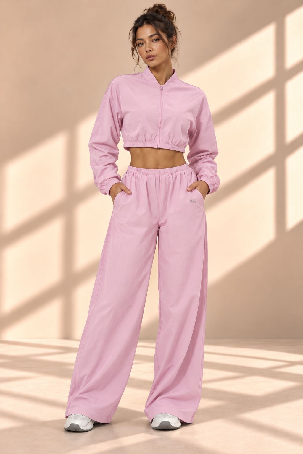 Front view of Blossom Track pink set with cropped zip-front jacket and wide-leg pants with pockets