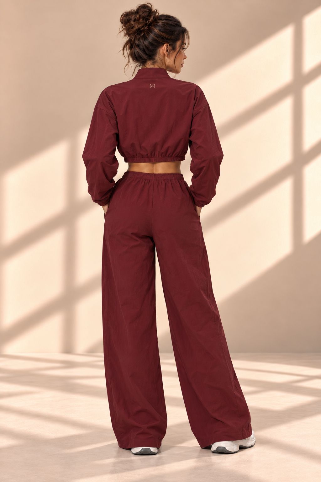 Back view of Bordeaux Track set showing gathered jacket hem and matching wide-leg pants