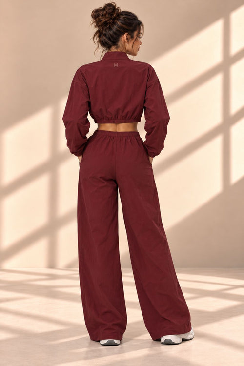 Back view of Bordeaux Track set showing gathered jacket hem and matching wide-leg pants