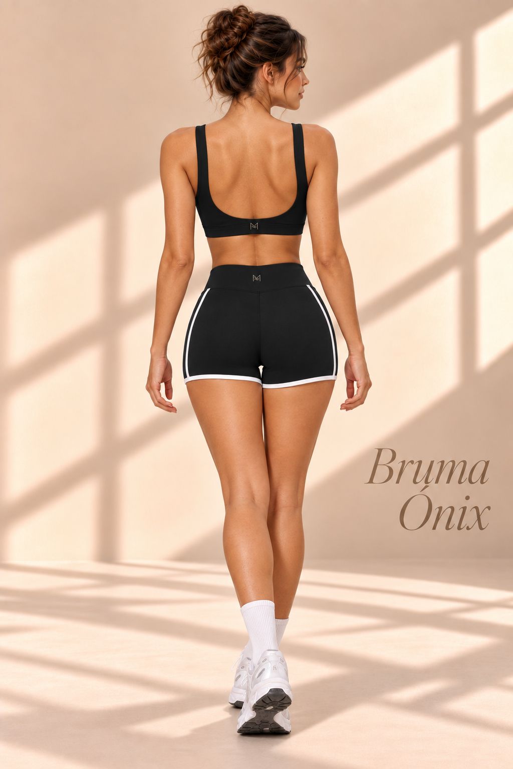 Back view of Bruma Onix black scoop-back top and high-waisted shorts