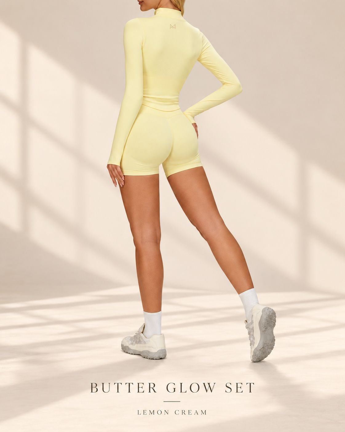 Back view of Butter Glow Set in Lemon Cream showing long-sleeved jacket and matching shorts