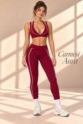 Front view of Carmesí Aura crimson V-neck crop top and matching leggings with white piping