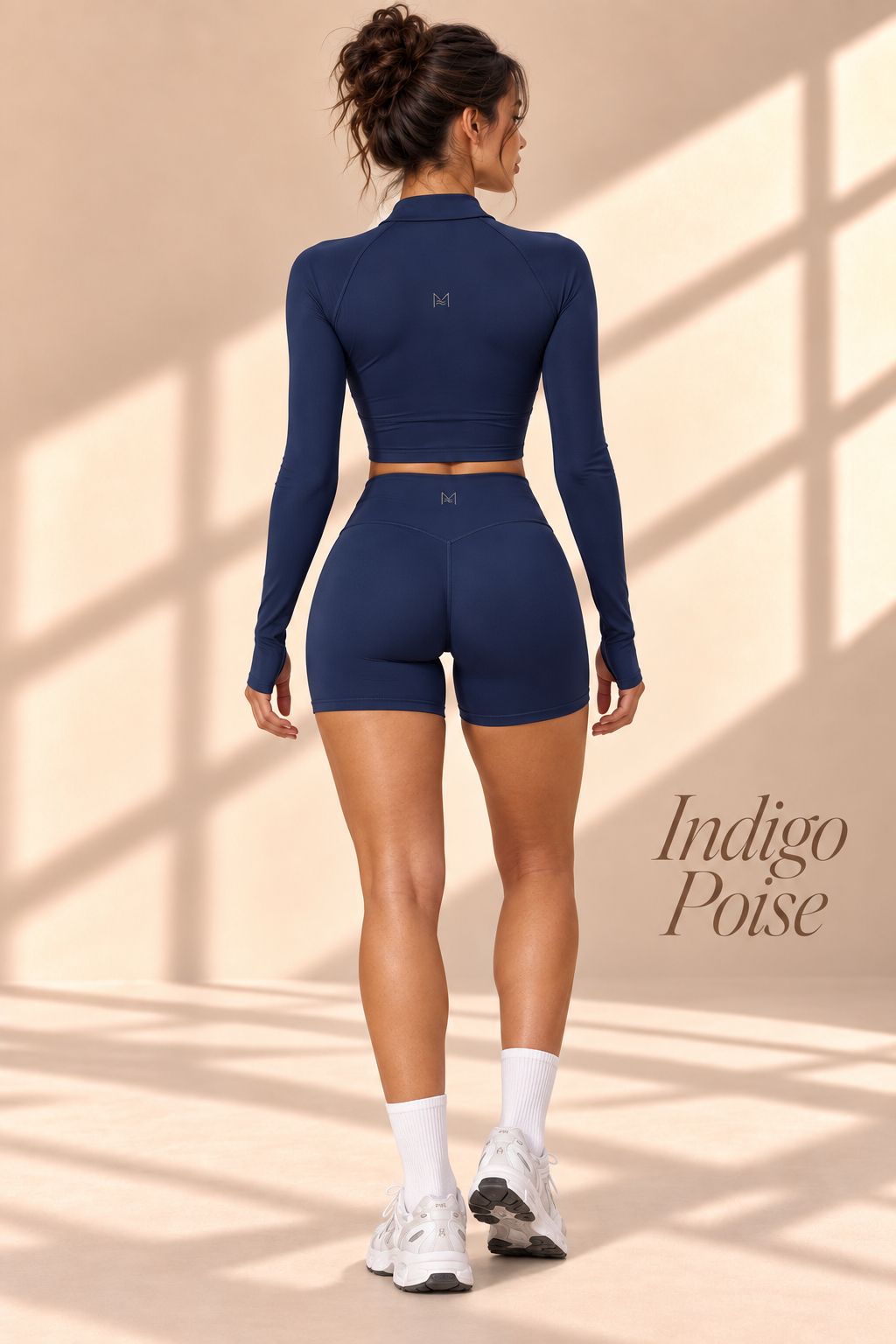 Back view of Indigo Poise indigo cropped jacket and high-waisted shorts