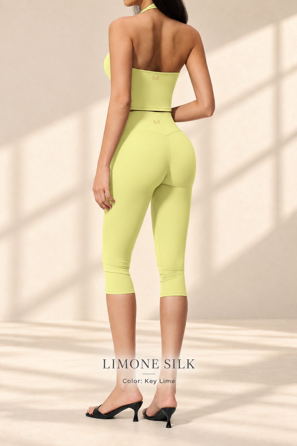 Back view of Limone Silk key-lime open-back halter top and matching capri leggings