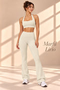 Back view of Marfil Lirio ivory open-back halter crop top and matching flare pants