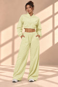 Front view of Matcha Track pale green set with cropped zip-front jacket and wide-leg pants with pockets