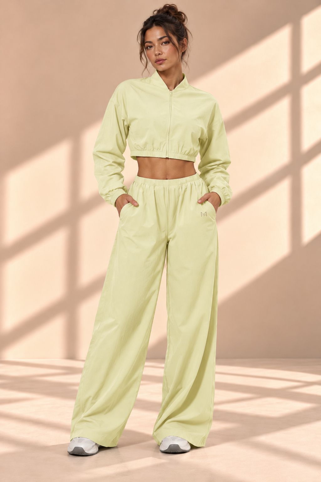 Front view of Matcha Track pale green set with cropped zip-front jacket and wide-leg pants with pockets