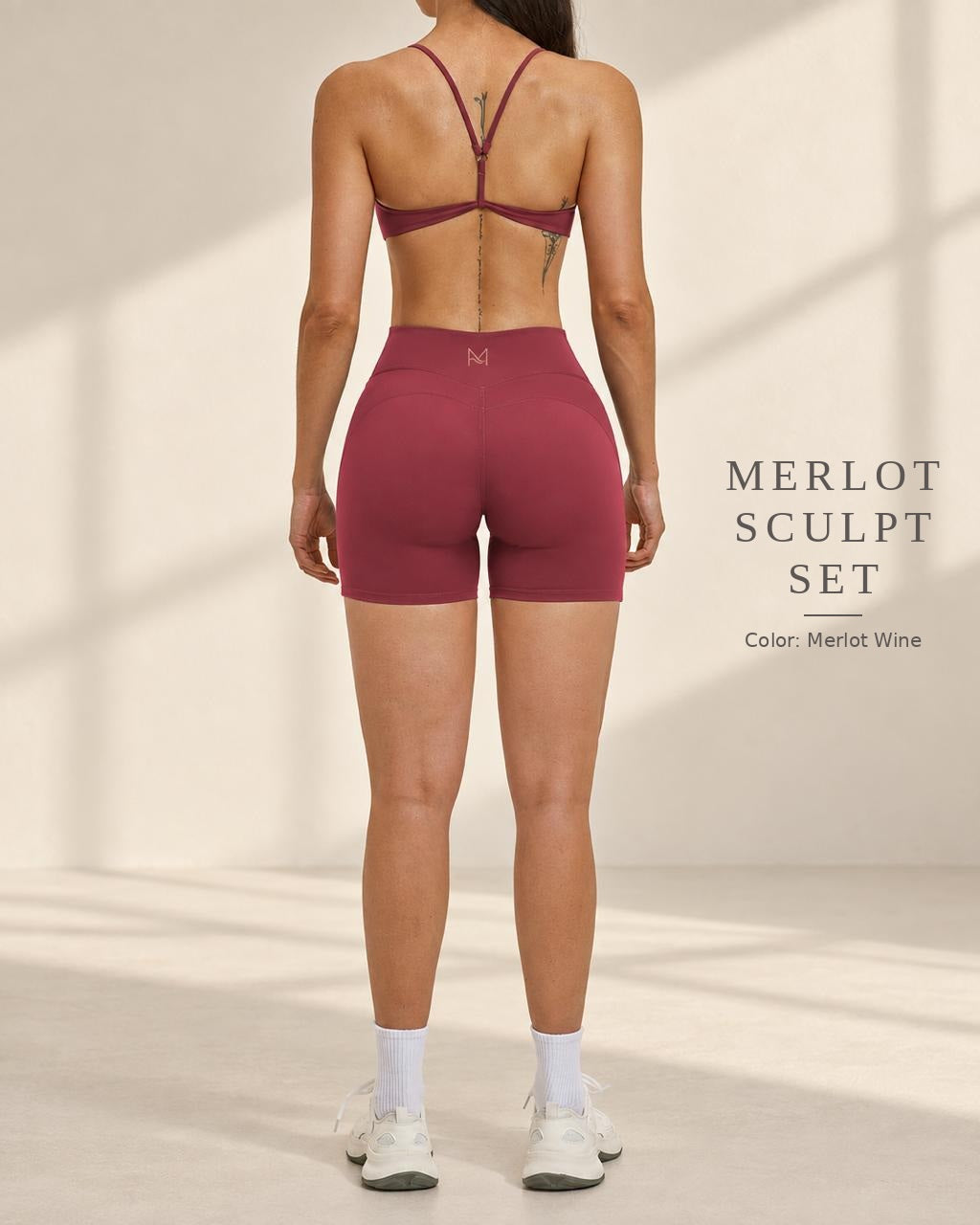 Back view of Merlot Sculpt Set in Merlot Wine showing open-back strap detail and fitted shorts