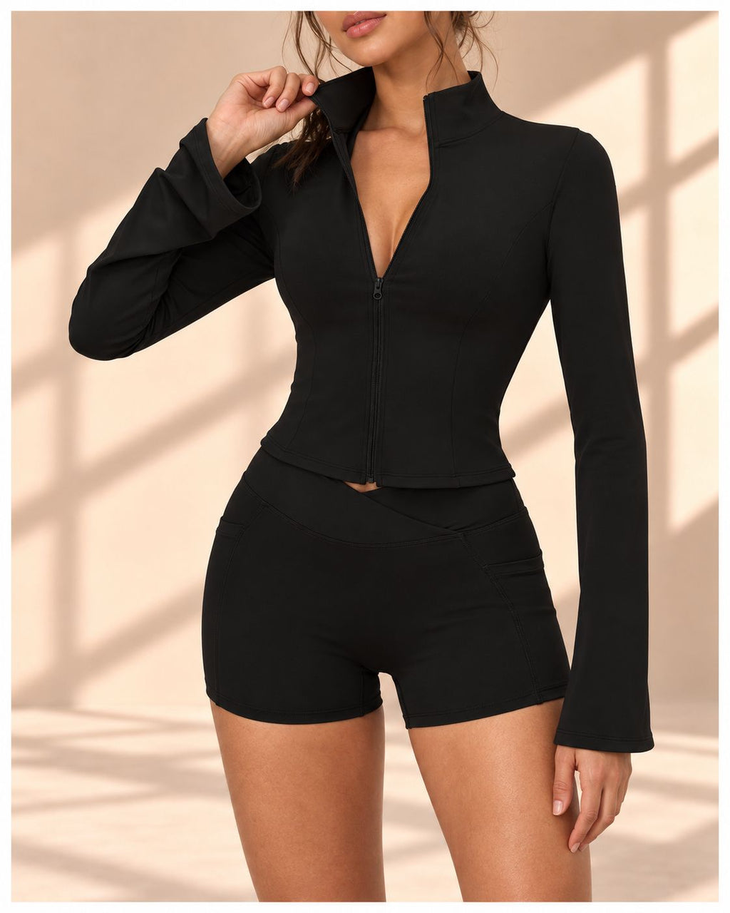 Front view of Noir Belle black set with zip-front bell-sleeve top and matching shorts