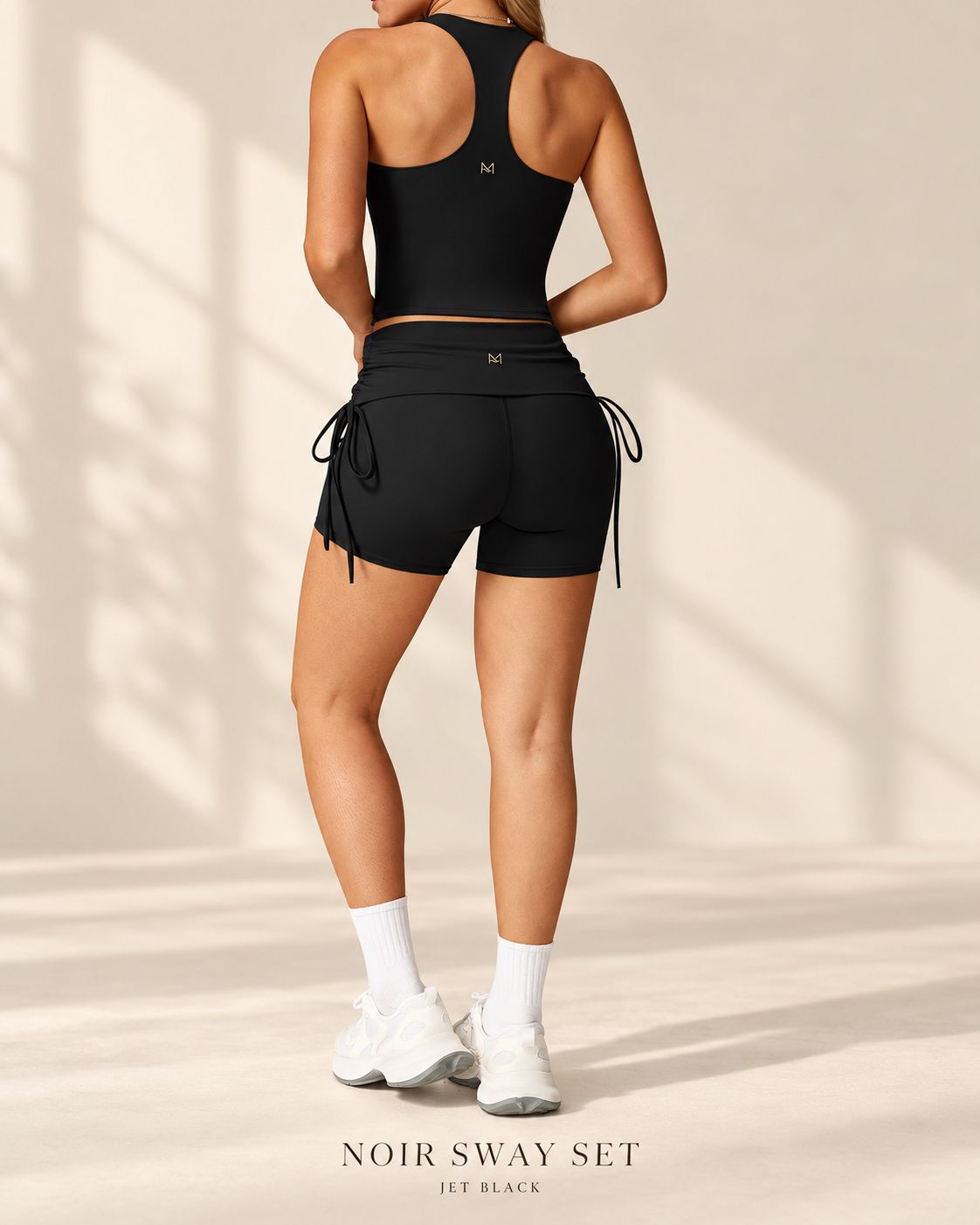 Back view of Noir Sway racerback crop top and matching shorts with gathered side ties