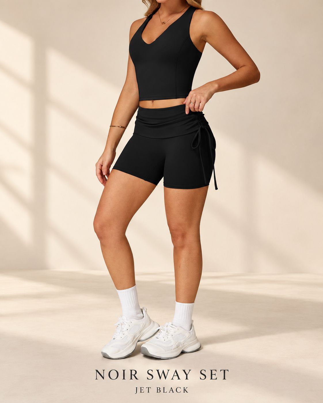 Front view of Noir Sway jet-black crop top and fitted shorts with side ties