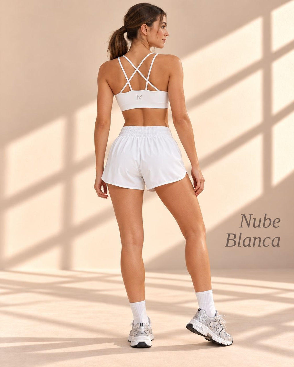 Back view of Nube Blanca white crop top with crisscross straps and matching shorts