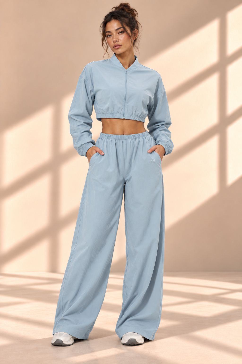 Front view of Powder Track blue set with cropped zip-front jacket and wide-leg pants with pockets