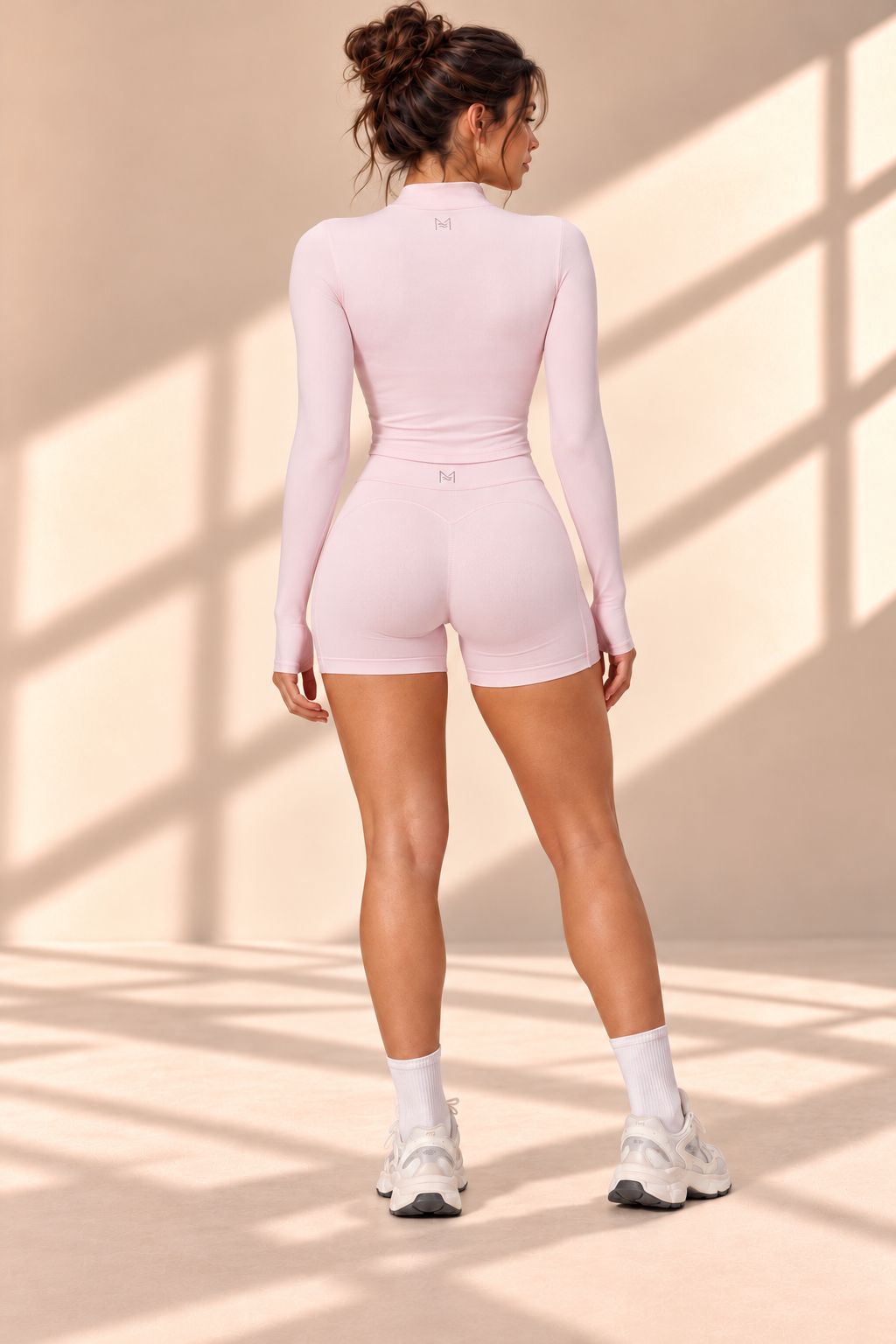 Back view of Rose Quartz pink set with fitted long-sleeve top and high-waisted shorts