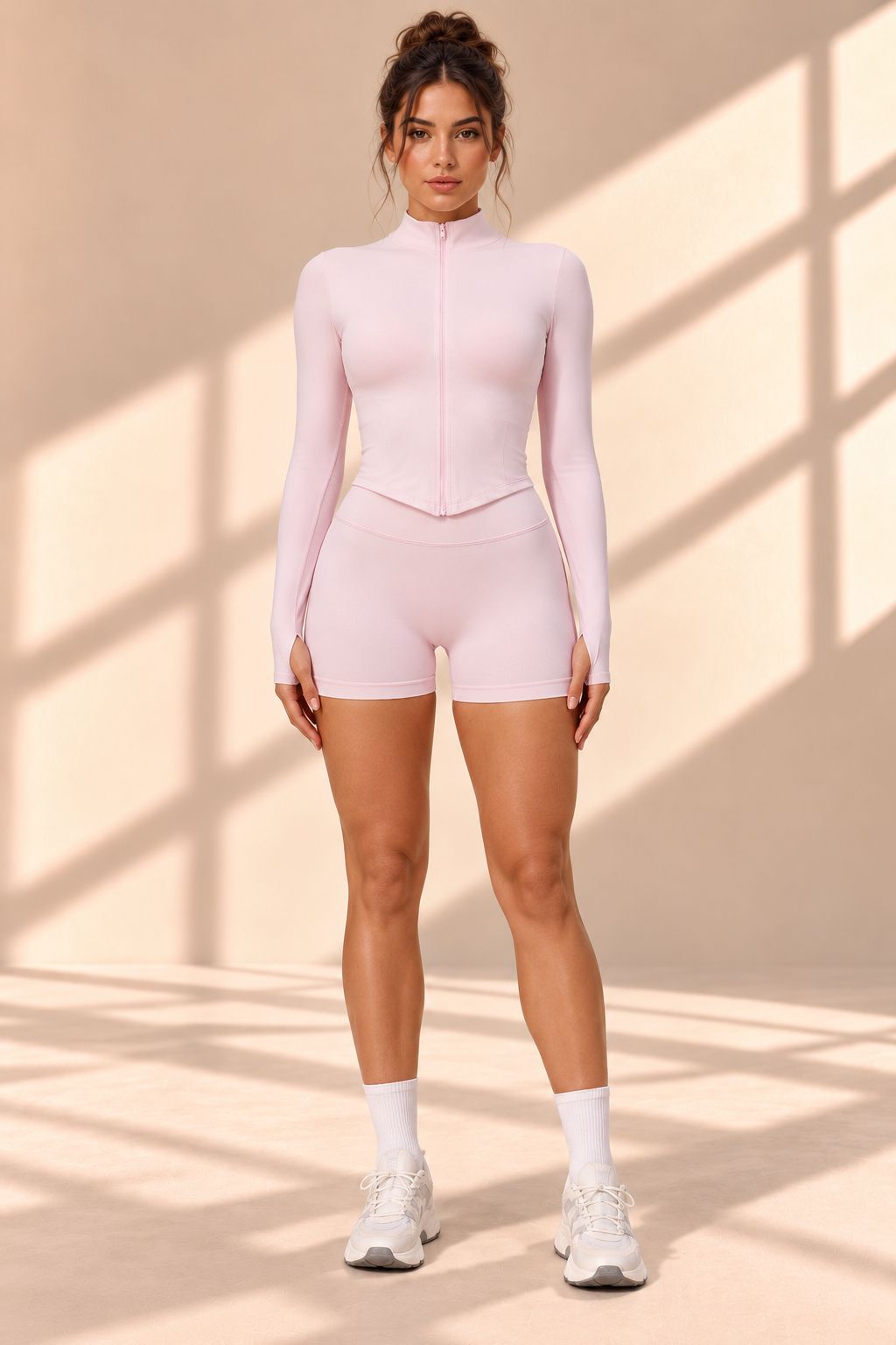 Front view of Rose Quartz pink set with zip-front thumbhole-cuff top and matching shorts