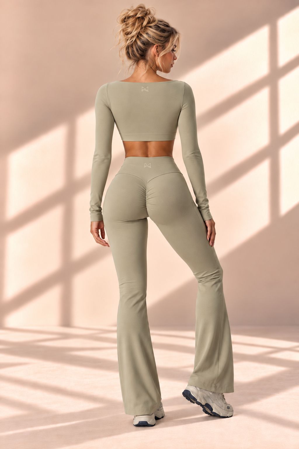Back view of Sage Contour set showing curved seams and gathered rear detail on flare pants