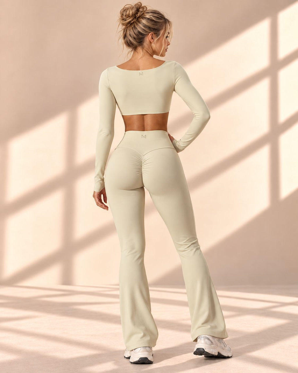 Back view of Vanilla Contour set showing curved seams and gathered rear detail on flare pants
