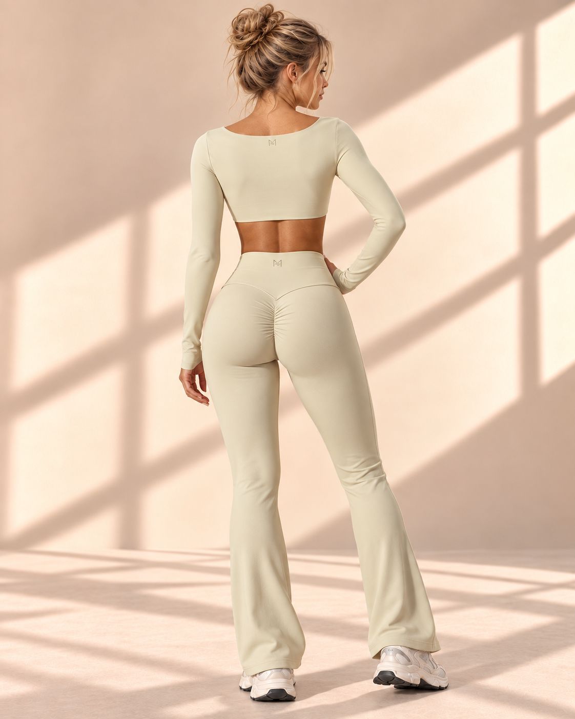 Back view of Vanilla Contour set showing curved seams and gathered rear detail on flare pants