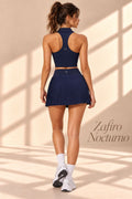 Front view of Zafiro Nocturno navy collared crop top and pleated mini skirt
