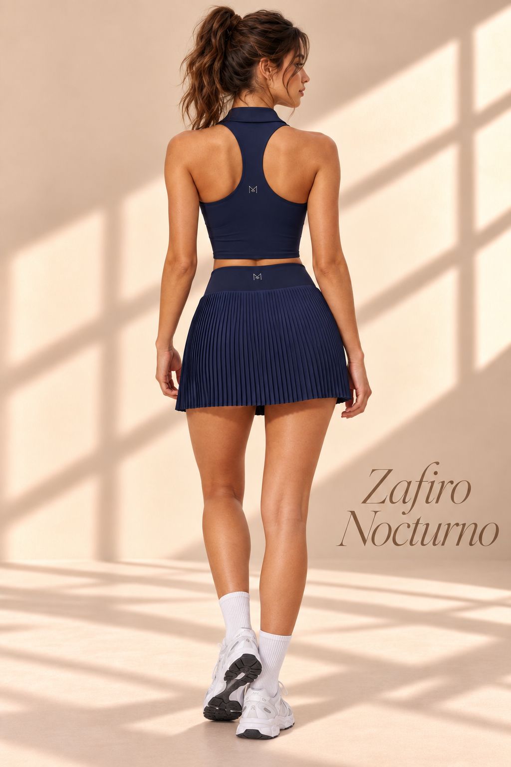 Front view of Zafiro Nocturno navy collared crop top and pleated mini skirt